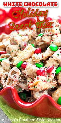 white chocolate holiday snack mix in a red bowl with green and red sprinkles