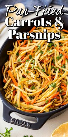 a pan filled with carrots and parmesan pasta next to an orange slice