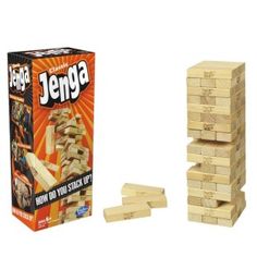 a stack of wooden blocks next to an unopened box of jenga game