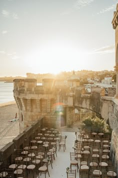 chairs are set up on the beach for an outdoor wedding ceremony at sunset or sunrise