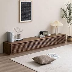 a living room with white walls and wooden furniture