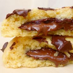 two pieces of chocolate filled biscuits sitting on top of each other with one bite taken out