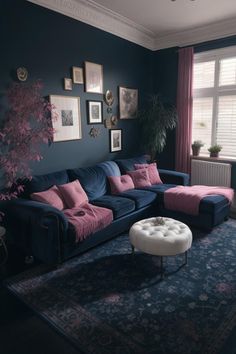 a living room with blue walls and pink pillows on the couches, rugs and windows