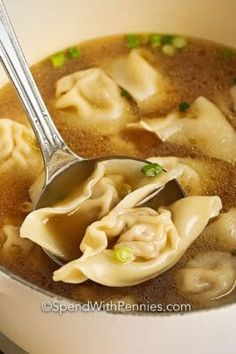 a ladle full of dumplings in broth