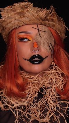 a woman with orange hair wearing a scarecrow hat and black eye make - up