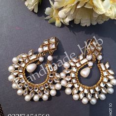 two pairs of earrings with pearls on them