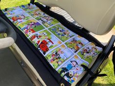 a child's car seat cover with cartoon characters on it