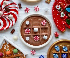 hot chocolate with marshmallows and candy canes on the table