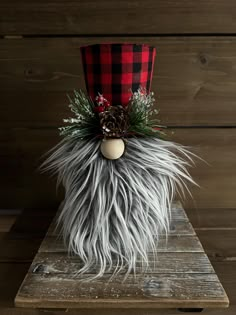 Winter Snowman Gnome is ready for the holidays.  The gnome is made with a polyester sock filled with  poly fil beads, and fiberfill. The beard is faux fur and the nose is a wooden  bead . He has on a checkerboard b/w top hat with faux greens and pinecones  and a glitter holly with berries.  They are weighted so they stand on their own - for decoration only - not a toy Making Gnomes, Gnome Christmas Decor, Snowman Gnome, Winter Gnomes, Snowman Crafts Diy, Holiday Gnomes, Christmas Floral Arrangements, Winter Snowman, Holiday Snowmen