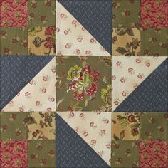 a patchwork quilt with flowers and leaves on it