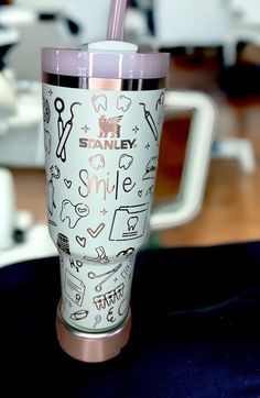 the tumbler cup is decorated with doodles and other things that are on it