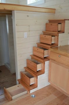 the stairs are made out of wood and have drawers on them