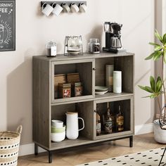 a shelf with coffee mugs, cups and other items on it next to a potted plant