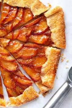 an apple pie with slices cut out and ready to be eaten