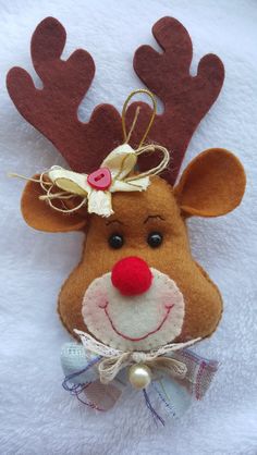 a stuffed reindeer head with a bow on it's head and a bell around its neck