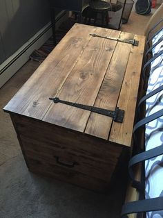 an old wooden box sitting on top of a bed