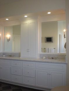 a large bathroom with double sinks and mirrors