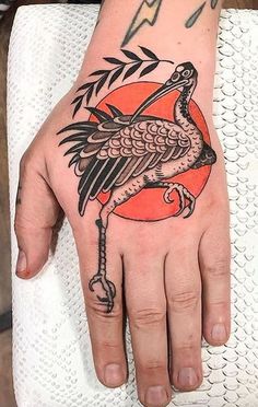 a person's hand with a bird tattoo on it