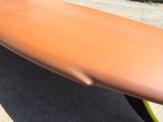 a close up of a surfboard on the ground