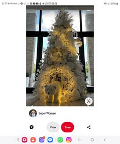 a white christmas tree decorated with lights and teddy bears