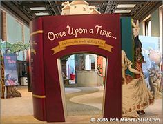 the entrance to a museum with an open door and sign that says, once upon a time