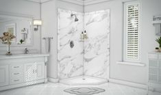 a bathroom with white marble walls and floors