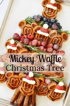 This Christmas tree charcuterie board is decked out with all the holiday trimmings. Made with Mickey gingerbread waffles, strawberry Santa hats, applewood bacon, fresh berries, sprigs of rosemary and even a tree trunk made out of sausages. Charcuterie Christmas, Christmas Charcuterie Boards, Mickey Waffle, Disney Christmas Party, Mickey Waffles, Christmas Breakfast Ideas, Christmas Charcuterie Board, Snack Boards, Christmas Charcuterie