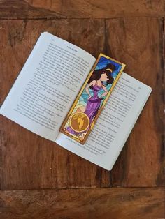 an open bookmark with the image of snow white and prince charmingly dressed on it