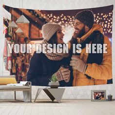 a man and woman standing next to each other in front of a wall hanging tapestry with the words your design is here