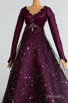 a doll wearing a purple dress with stars on it