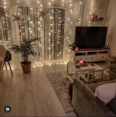 a living room filled with furniture and christmas lights