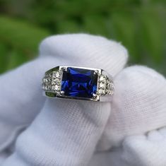 a blue ring sitting on top of a white glove