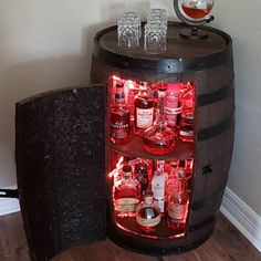 a wine barrel with liquor bottles in it