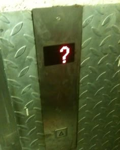 an elevator with a red question mark on the front and bottom panel that says, you are not entering the elevator level