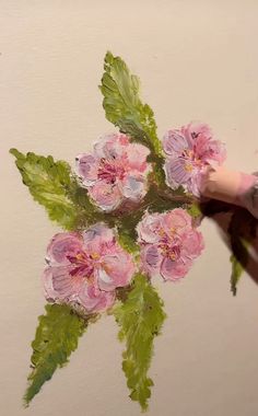 a painting of pink flowers with green leaves