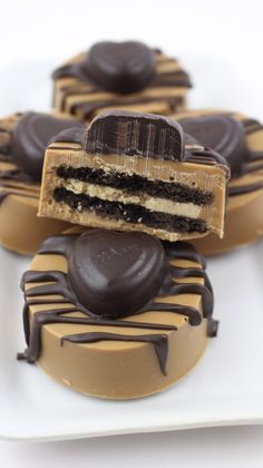 chocolate covered desserts are arranged on white plates