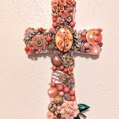 a cross made out of beads and flowers