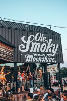 a group of people standing outside of a building with the words one smoky on it