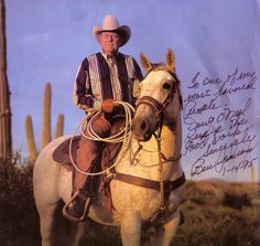 a man wearing a cowboy hat is sitting on a white horse with a poem written in it