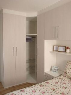 a bedroom with a bed, dresser and closets in the corner next to each other