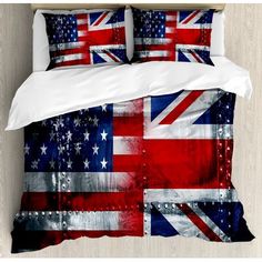 a bed with an american and british flag design on the cover, along with two pillows