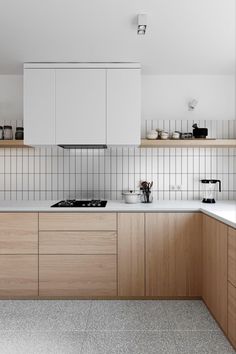 a kitchen with wooden cabinets and white counter tops