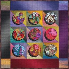 a quilted wall hanging with many different colored circles and flowers on it's sides