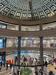 the inside of a building with people walking around