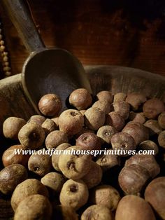 a bowl full of nuts with a wooden spoon