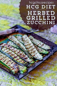 grilled zucchini on a pan with text overlay that reads hgg diet herbed grilled zucchini