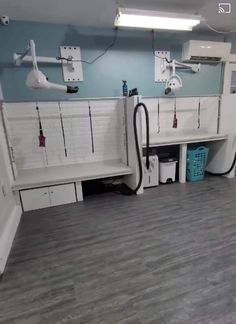 the inside of a dental office with white cabinets and gray wood flooring is shown