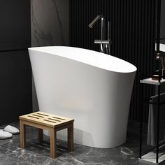 a white bath tub sitting on top of a bathroom floor next to a wooden stool