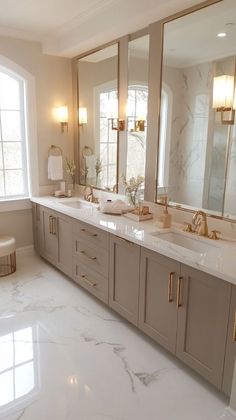 a large bathroom with two sinks and mirrors