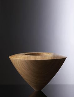 a wooden bowl sitting on top of a table